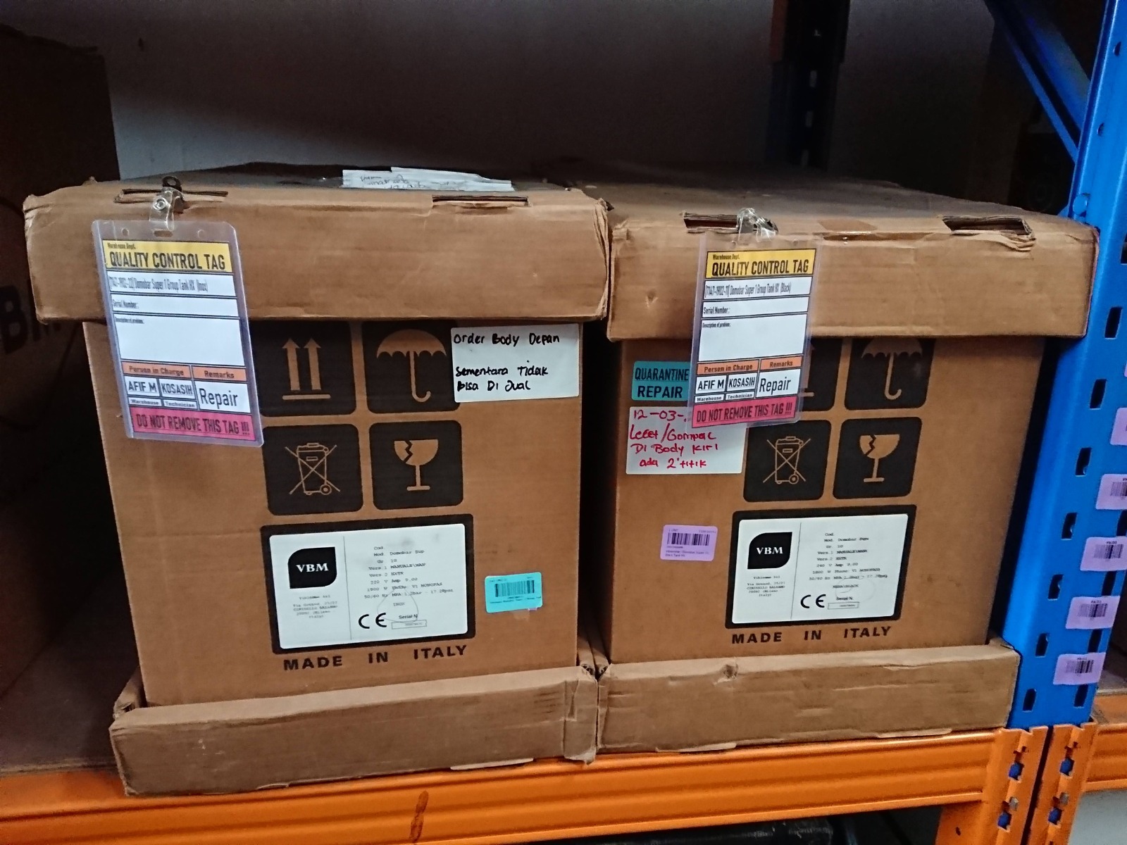 Product cartons on a warehouse rack carrying quality control tags marked quarantine and repair